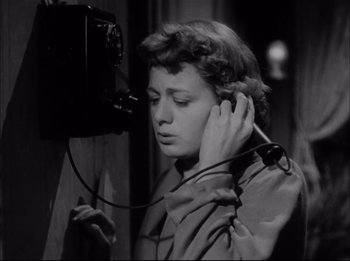 Movie still from “A Place in the Sun” (1951), directed by George Stevens – A black - and - white photo of a woman holding a phone; Close Up shot, Low angle