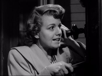 Movie still from “A Place in the Sun” (1951), directed by George Stevens – An old black and white photo of a woman talking on a phone; Close Up shot, Low angle