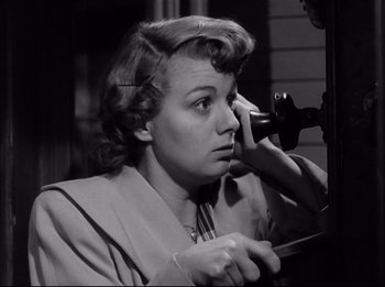 Movie still from “A Place in the Sun” (1951), directed by George Stevens – An old photo of a woman talking on a phone; Close Up shot, Low angle