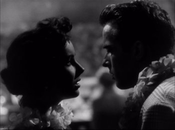 Movie still from “A Place in the Sun” (1951), directed by George Stevens – A man and a woman face to face in a black and white photo; Close Up shot, Low angle