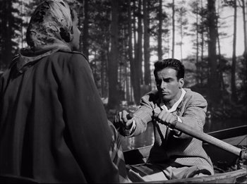 Movie still from “A Place in the Sun” (1951), directed by George Stevens – A black and white photo of a man in a boat; Medium shot, High angle
