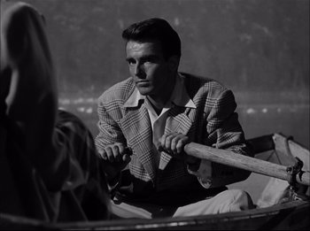 Movie still from “A Place in the Sun” (1951), directed by George Stevens – A black and white photo of a man rowing a boat; Close Up shot, Over the shoulder angle