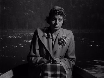 Movie still from “A Place in the Sun” (1951), directed by George Stevens – An old photo of a woman sitting in a boat; Medium shot, High angle