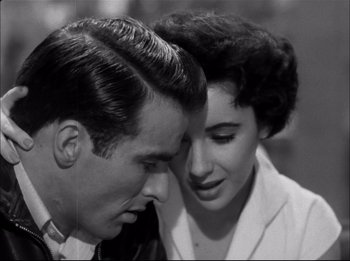 Movie still from “A Place in the Sun” (1951), directed by George Stevens – A man and a woman looking at one another; Close Up shot, High angle
