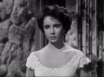 Movie still from “A Place in the Sun” (1951), directed by George Stevens – A black - and - white photo of a woman in a white dress; Close Up shot, High angle