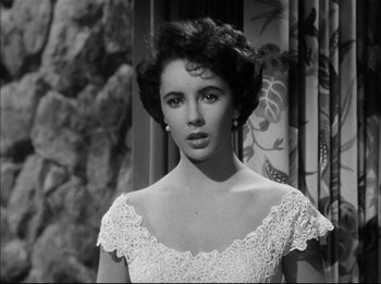 Movie still from “A Place in the Sun” (1951), directed by George Stevens – A black - and - white photo of a woman in a white dress; Close Up shot, High angle