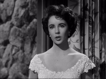 Movie still from “A Place in the Sun” (1951), directed by George Stevens – A black - and - white photo of a woman in a white dress; Close Up shot, Low angle