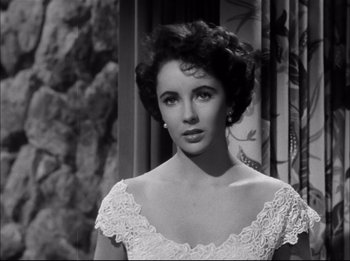 Movie still from “A Place in the Sun” (1951), directed by George Stevens – A black - and - white photo of a woman in a white dress; Close Up shot, Low angle