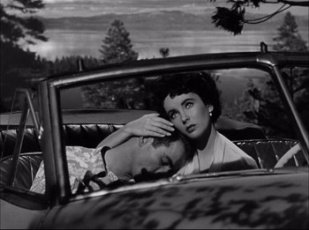 Movie still from “A Place in the Sun” (1951), directed by George Stevens – An old photo of a man and a woman in the back of a car; Medium shot, High angle