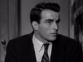 Movie still from “A Place in the Sun” (1951), directed by George Stevens – Black and white photograph of a man wearing a suit and tie; Close Up shot, Low angle