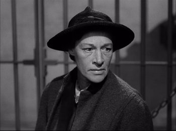 Movie still from “A Place in the Sun” (1951), directed by George Stevens – An old black and white photo of a man wearing a hat; Close Up shot, High angle