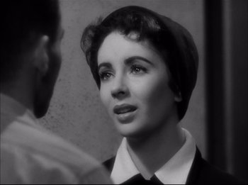 Movie still from “A Place in the Sun” (1951), directed by George Stevens – A woman with a head scarf looking to her left; Close Up shot, Over the shoulder angle