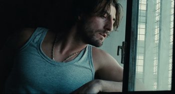 Movie still from “A Prophet” (2009), directed by Jacques Audiard – A person wearing a tank top; Close Up shot, Low angle
