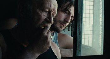 Movie still from “A Prophet” (2009), directed by Jacques Audiard – A man and a man looking in a mirror; Close Up shot, Over the shoulder angle