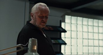 Movie still from “A Prophet” (2009), directed by Jacques Audiard – An older man standing in front of a lamp; Close Up shot, Low angle