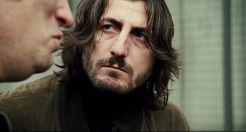 Movie still from “A Prophet” (2009), directed by Jacques Audiard – A person with long hair; Close Up shot, Over the shoulder angle
