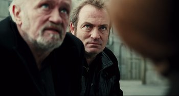 Movie still from “A Prophet” (2009), directed by Jacques Audiard – Two men looking at each other while standing next to each other; Close Up shot, Over the shoulder angle