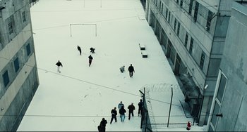 Movie still from “A Prophet” (2009), directed by Jacques Audiard – A group of people are skiing in the snow; Extreme Wide shot, High angle