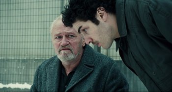 Movie still from “A Prophet” (2009), directed by Jacques Audiard – A man and a man looking at each other; Close Up shot, Over the shoulder angle