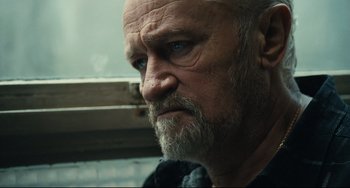 Movie still from “A Prophet” (2009), directed by Jacques Audiard – An older man with a beard and a mustache; Close Up shot, Low angle