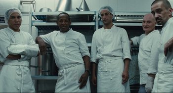 Movie still from “A Prophet” (2009), directed by Jacques Audiard – Two chefs standing next to each other in a kitchen; Medium shot, Low angle