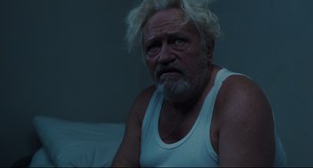 Movie still from “A Prophet” (2009), directed by Jacques Audiard – An older man with white hair sitting on a bed; Close Up shot, Over the shoulder angle