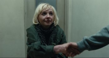 Movie still from “A Prophet” (2009), directed by Jacques Audiard – A woman in a green jacket shaking a man's hand; Close Up shot, Over the shoulder angle