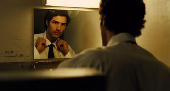 Movie still from “A Prophet” (2009), directed by Jacques Audiard – A man looking at himself in the mirror; Close Up shot, Over the shoulder angle