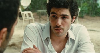 Movie still from “A Prophet” (2009), directed by Jacques Audiard – A person wearing a white shirt; Close Up shot, Over the shoulder angle
