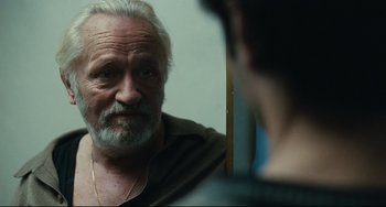 Movie still from “A Prophet” (2009), directed by Jacques Audiard – An older man looking at a younger man in a mirror; Close Up shot, Over the shoulder angle