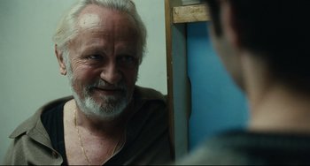 Movie still from “A Prophet” (2009), directed by Jacques Audiard – An older man looking at himself in the mirror; Close Up shot, Over the shoulder angle