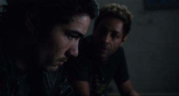 Movie still from “A Prophet” (2009), directed by Jacques Audiard – Two young men sitting next to each other in a dark room; Close Up shot, Over the shoulder angle