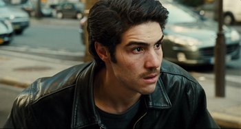 Movie still from “A Prophet” (2009), directed by Jacques Audiard – A person wearing a leather jacket; Close Up shot, High angle