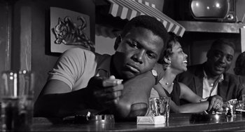 A black and white photo of a man and a woman sitting at a table