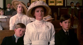Movie still from “A River Runs Through It” (1992), directed by Robert Redford – A group of people sitting in a room; Medium shot, Low angle