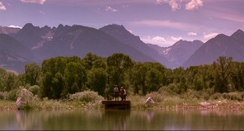 Movie still from “A River Runs Through It” (1992), directed by Robert Redford – Two men standing on a dock in the middle of a lake; Extreme Wide shot, Low angle