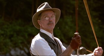 Movie still from “A River Runs Through It” (1992), directed by Robert Redford – An older man wearing a hat and holding a whip; Close Up shot, Low angle