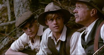 Movie still from “A River Runs Through It” (1992), directed by Robert Redford – A group of men wearing hats sitting next to each other; Medium shot, Over the shoulder angle