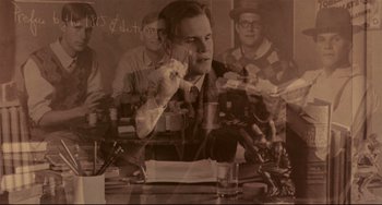 Movie still from “A River Runs Through It” (1992), directed by Robert Redford – A man sitting at a table in front of a glass of water; Medium shot, Low angle