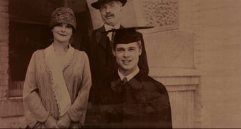 Movie still from “A River Runs Through It” (1992), directed by Robert Redford – An old photo of a man and a woman and a man holding a hat; Extreme Close Up shot, Overhead angle
