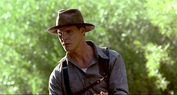Movie still from “A River Runs Through It” (1992), directed by Robert Redford – A man wearing a hat and holding a camera; Close Up shot, Over the shoulder angle