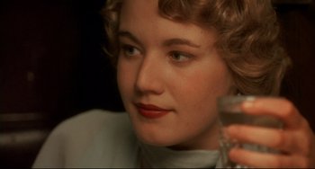 Movie still from “A River Runs Through It” (1992), directed by Robert Redford – A person holding a glass of wine; Close Up shot, Over the shoulder angle