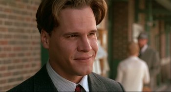 Movie still from “A River Runs Through It” (1992), directed by Robert Redford – A person wearing a suit and tie; Close Up shot, Low angle