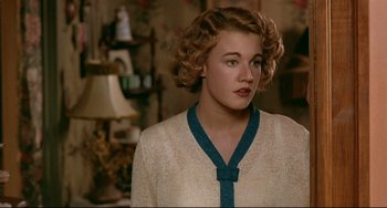 Movie still from “A River Runs Through It” (1992), directed by Robert Redford – A young woman with blonde hair wearing a white sweater; Close Up shot, Over the shoulder angle