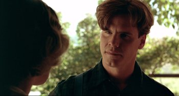Movie still from “A River Runs Through It” (1992), directed by Robert Redford – A young man is talking to another young man outside; Close Up shot, Over the shoulder angle