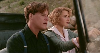 Movie still from “A River Runs Through It” (1992), directed by Robert Redford – A man and a woman standing next to each other in front of rocks; Close Up shot, Low angle