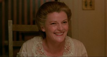 Movie still from “A River Runs Through It” (1992), directed by Robert Redford – A person wearing a dress smiling; Close Up shot, High angle