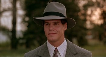 Movie still from “A River Runs Through It” (1992), directed by Robert Redford – A man wearing a suit and a hat; Close Up shot, Low angle