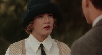 Movie still from “A River Runs Through It” (1992), directed by Robert Redford – A woman wearing a black hat and a white shirt; Close Up shot, Over the shoulder angle