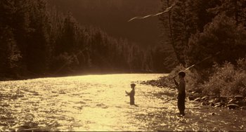 Movie still from “A River Runs Through It” (1992), directed by Robert Redford – A man and a child fly a kite in a river; Extreme Wide shot, High angle